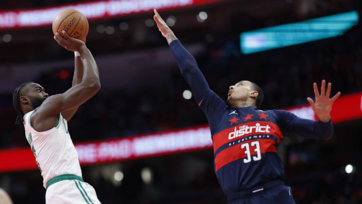 Nov 22, 2024; Washington, District of Columbia, USA; Boston Celtics guard Jaylen Brown (7) shoots the ball as Washington Wizards forward Kyle Kuzma (33) defends in the first half at Capital One Arena. Mandatory Credit: Geoff Burke-Imagn Images