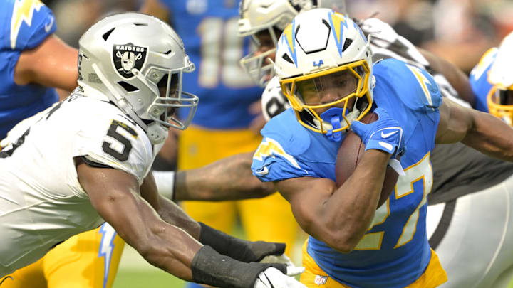 Sep 8, 2024; Inglewood, California, USA; Los Angeles Chargers running back J.K. Dobbins (27) breaks away from Las Vegas Raiders linebacker Divine Deablo (5) and runs for a touchdown in the second half at SoFi Stadium. Mandatory Credit: Jayne Kamin-Oncea-Imagn Images
