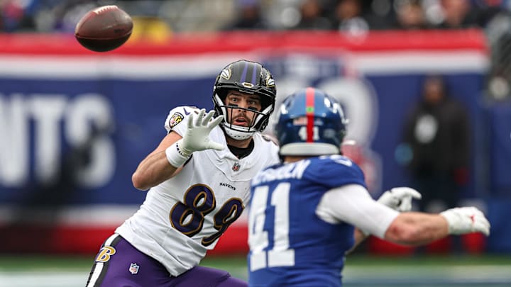 Dec 15, 2024; East Rutherford, New Jersey, USA; Baltimore Ravens tight end Mark Andrews (89) makes a catch during the first half in front of New York Giants linebacker Micah McFadden (41) at MetLife Stadium. Mandatory Credit: Vincent Carchietta-Imagn Images