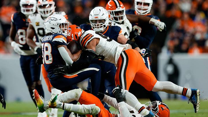 Dec 2, 2024; Denver, Colorado, USA; Denver Broncos running back Jaleel McLaughlin (38) is tackled by Cleveland Browns linebacker Mohamoud Diabate (43) and linebacker Winston Reid (59) in the fourth quarter at Empower Field at Mile High. Mandatory Credit: Isaiah J. Downing-Imagn Images