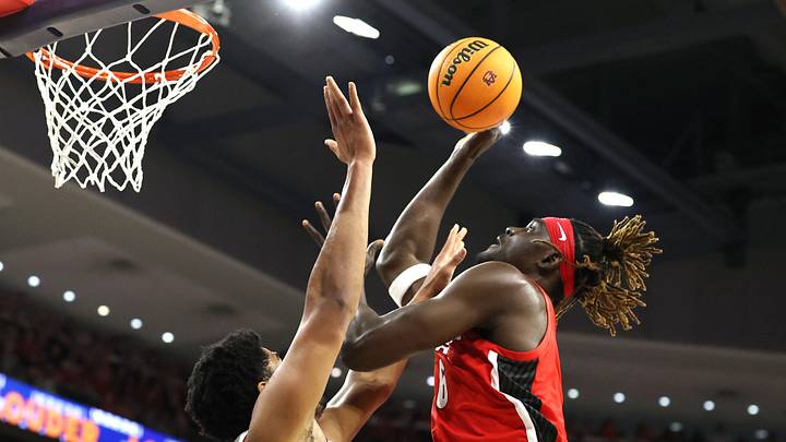 Feb 22, 2025; Auburn, Alabama, USA;  Georgia Bulldogs center Somto Cyril (6) shoots over Auburn Tigers center Dylan Cardwell (44) during the first half at Neville Arena. Mandatory Credit: John Reed-Imagn Images