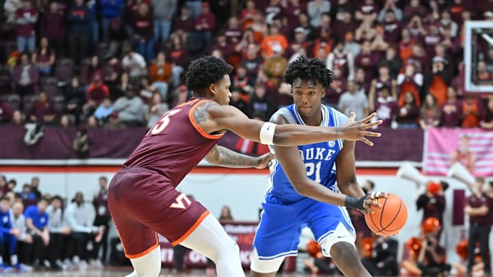 Jan 31, 2026; Blacksburg, Virginia, USA;  Duke Blue Devils center Patrick Ngongba (21) looks to pass the ball as Virginia Tech Hokies forward Amani Hansberry (13) defends during the first half at Cassell Coliseum. Mandatory Credit: Brian Bishop-Imagn Images