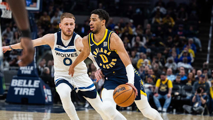Mar 24, 2025; Indianapolis, Indiana, USA; Indiana Pacers guard Tyrese Haliburton (0) dribbles the ball while Minnesota Timberwolves guard Donte DiVincenzo (0) defends in the second half at Gainbridge Fieldhouse. Mandatory Credit: Trevor Ruszkowski-Imagn Images Mar 24, 2025; Indianapolis, Indiana, USA; Indiana Pacers guard Tyrese Haliburton (0) dribbles the ball while Minnesota Timberwolves guard Donte DiVincenzo (0) defends in the second half at Gainbridge Fieldhouse. Mandatory Credit: Trevor Ruszkowski-Imagn Images
