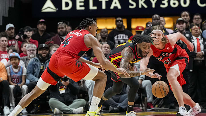 Feb 23, 2024; Atlanta, Georgia, USA; Atlanta Hawks forward Saddiq Bey (41) goes after a loose ball between Toronto Raptors forwards Scottie Barnes (4) and Kelly Olynyk (41) during the second half at State Farm Arena. Mandatory Credit: Dale Zanine-Imagn Images