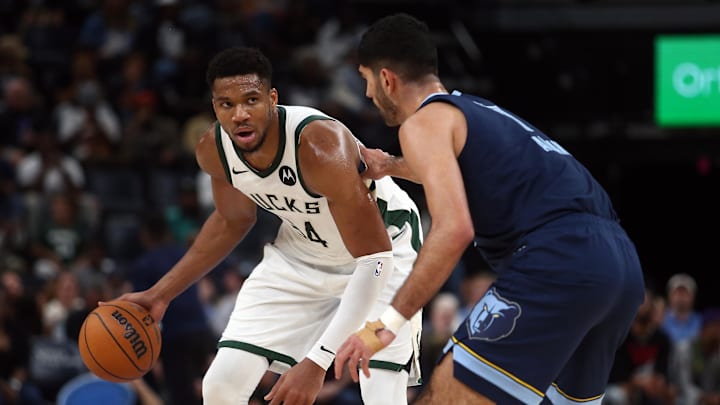 Oct 31, 2024; Memphis, Tennessee, USA; Milwaukee Bucks forward Giannis Antetokounmpo (34) dribbles as Memphis Grizzlies forward Santi Aldama (7) defends during the first half at FedExForum. Mandatory Credit: Petre Thomas-Imagn Images