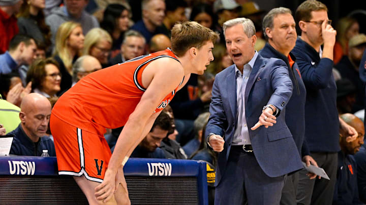 Jan 17, 2026; Dallas, Texas, USA; Virginia Cavaliers head coach Ryan Odom talks with center Johann Grunloh (17) during the first half against the SMU Mustangs at Moody Coliseum. Mandatory Credit: Jerome Miron-Imagn Images