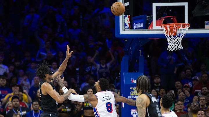 Feb 22, 2025; Philadelphia, Pennsylvania, USA; Brooklyn Nets center Nic Claxton (33) scores the game winning shot past Philadelphia 76ers forward Paul George (8) as time expires at Wells Fargo Center. Mandatory Credit: Bill Streicher-Imagn Images Feb 22, 2025; Philadelphia, Pennsylvania, USA; Brooklyn Nets center Nic Claxton (33) scores the game winning shot past Philadelphia 76ers forward Paul George (8) as time expires at Wells Fargo Center. Mandatory Credit: Bill Streicher-Imagn Images