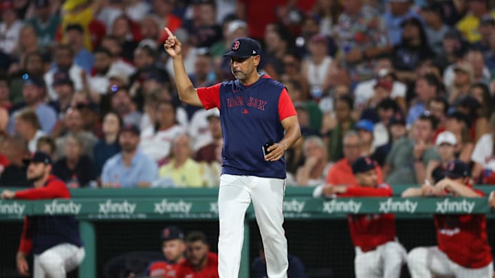 Jul 2, 2025; Boston, Massachusetts, USA; Boston Red Sox manager Alex Cora (13) makes a pitching change during the seventh inning against the Cincinnati Reds at Fenway Park. Mandatory Credit: Paul Rutherford-Imagn Images