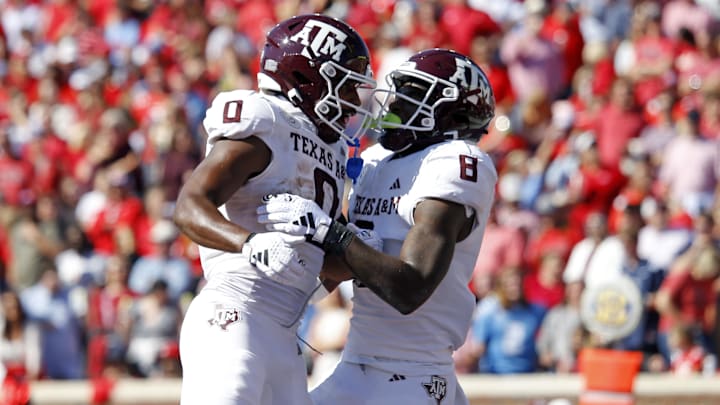 Nov 4, 2023; Oxford, Mississippi, USA; Texas A&M Aggies wide receiver Ainias Smith (0) and running back Le'Veon Moss (8) react after a touchdown during the first half at Vaught-Hemingway Stadium. Mandatory Credit: Petre Thomas-USA TODAY Sports