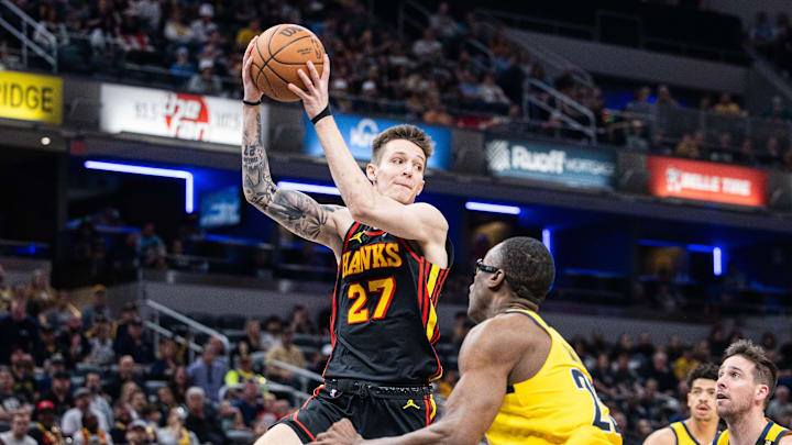 Apr 14, 2024; Indianapolis, Indiana, USA; Atlanta Hawks guard Vit Krejci (27) passes the ball while Atlanta Hawks guard Garrison Mathews (25) defends in the second half at Gainbridge Fieldhouse. Mandatory Credit: Trevor Ruszkowski-Imagn Images