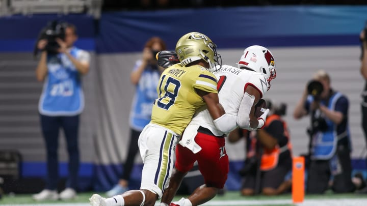 Sep 1, 2023; Atlanta, Georgia, USA; Louisville Cardinals wide receiver Jamari Thrash (1) catches a touchdown pass past Georgia Tech Yellow Jackets defensive back Ahmari Harvey (18) in the second half at Mercedes-Benz Stadium. Mandatory Credit: Brett Davis-USA TODAY Sports Sep 1, 2023; Atlanta, Georgia, USA; Louisville Cardinals wide receiver Jamari Thrash (1) catches a touchdown pass past Georgia Tech Yellow Jackets defensive back Ahmari Harvey (18) in the second half at Mercedes-Benz Stadium. Mandatory Credit: Brett Davis-USA TODAY Sports