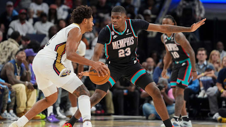 Grizzlies' Cedric Coward (23) guards Pelicans' Jordan Poole (3) during the home opener against the New Orleans Pelicans at FedExForum on October 22, 2025. Grizzlies' Cedric Coward (23) guards Pelicans' Jordan Poole (3) during the home opener against the New Orleans Pelicans at FedExForum on October 22, 2025.