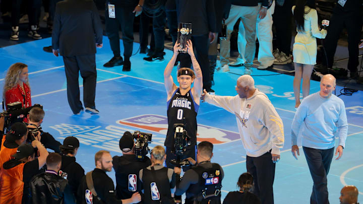 Feb 17, 2024; Indianapolis, IN, USA; Osceola Magic guard Mac McClung (0) celebrates after winning the AT&T Slam Dunk Contest during NBA All Star Saturday Night at Lucas Oil Stadium. Mandatory Credit: Trevor Ruszkowski-Imagn Images