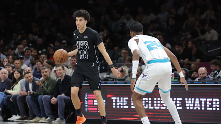 Mar 31, 2026; Brooklyn, New York, USA; Brooklyn Nets guard Nolan Traore (88) controls the ball against Charlotte Hornets forward Brandon Miller (24) during the first quarter at Barclays Center. Mandatory Credit: Brad Penner-Imagn Images