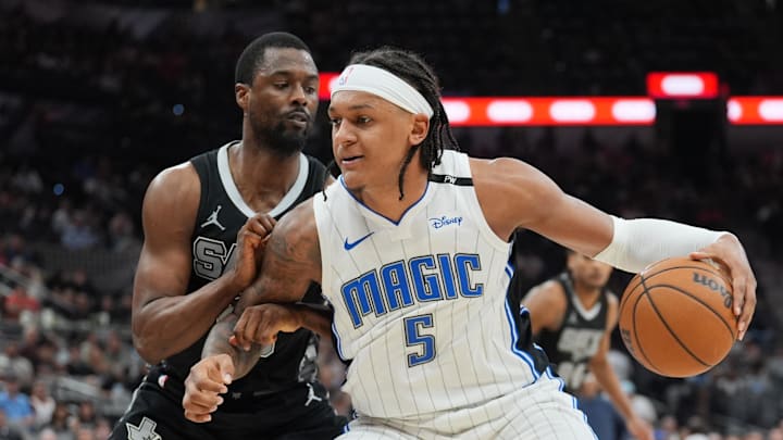 Apr 1, 2025; San Antonio, Texas, USA; Orlando Magic forward Paolo Banchero (5) dribbles against San Antonio Spurs forward Harrison Barnes (40) in the second half at Frost Bank Center. Mandatory Credit: Daniel Dunn-Imagn Images Apr 1, 2025; San Antonio, Texas, USA; Orlando Magic forward Paolo Banchero (5) dribbles against San Antonio Spurs forward Harrison Barnes (40) in the second half at Frost Bank Center. Mandatory Credit: Daniel Dunn-Imagn Images