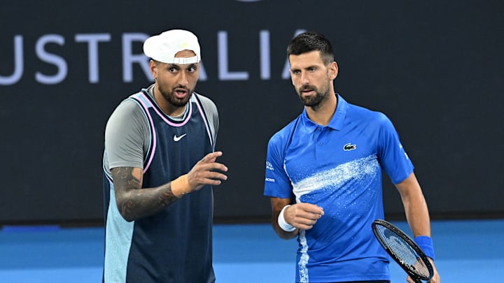 Nick Kyrgios (left) and Novak Djokovic (right) in action during the doubles match at the Brisbane international.
