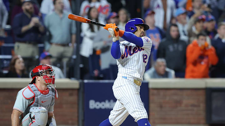 Oct 9, 2024; New York, New York, USA; New York Mets shortstop Francisco Lindor (12) hits a grand slam against the Philadelphia Phillies in the sixth inning in game four of the NLDS for the 2024 MLB Playoffs at Citi Field. Mandatory Credit: Brad Penner-Imagn Images