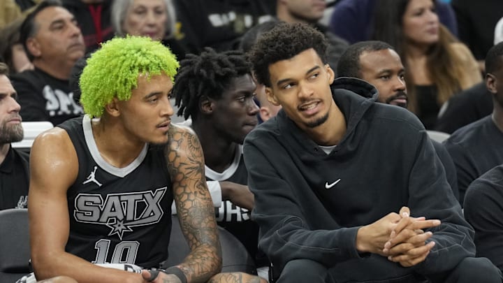 Dec 5, 2024; San Antonio, Texas, USA; Injured San Antonio Spurs center Victor Wembanyama (1) talks with forward Jeremy Sochan (10) during the first half at Frost Bank Center. Mandatory Credit: Scott Wachter-Imagn Images Dec 5, 2024; San Antonio, Texas, USA; Injured San Antonio Spurs center Victor Wembanyama (1) talks with forward Jeremy Sochan (10) during the first half at Frost Bank Center. Mandatory Credit: Scott Wachter-Imagn Images