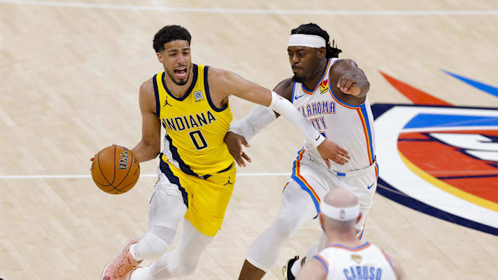 Jun 16, 2025; Oklahoma City, Oklahoma, USA; Indiana Pacers guard Tyrese Haliburton (0) drives to the basket past Oklahoma City Thunder guard Luguentz Dort (5) during the third quarter in game five of the 2025 NBA Finals at Paycom Center. Mandatory Credit: Alonzo Adams-Imagn Images
