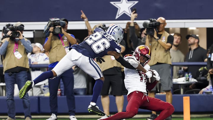 Jan 5, 2025; Arlington, Texas, USA;  Washington Commanders wide receiver Terry McLaurin (17) makes the game-winning touchdown catch over Dallas Cowboys cornerback DaRon Bland (26) during the fourth quarter at AT&T Stadium. Mandatory Credit: Kevin Jairaj-Imagn Images