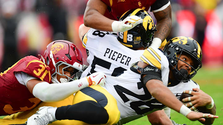 Nov 15, 2025; Los Angeles, California, USA; Iowa Hawkeyes running back Kamari Moulton (28) runs the ball against Southern California Trojans linebacker Jadyn Walker (31) during the second half at the Los Angeles Memorial Coliseum. Mandatory Credit: Gary A. Vasquez-Imagn Images