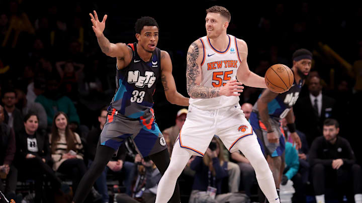 Dec 20, 2023; Brooklyn, New York, USA; New York Knicks center Isaiah Hartenstein (55) controls the ball against Brooklyn Nets center Nic Claxton (33) during the third quarter at Barclays Center. Mandatory Credit: Brad Penner-USA TODAY Sports