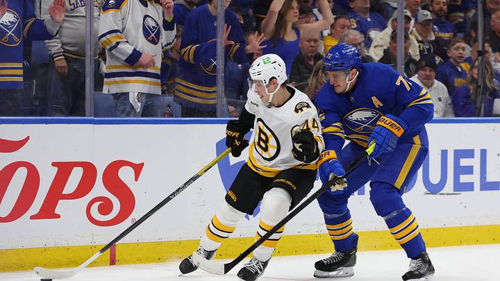 Apr 19, 2026; Buffalo, New York, USA; Boston Bruins center James Hagens (44) tries to control the puck as Buffalo Sabres center Tage Thompson (72) defends during the third period in game one of the first round of the 2026 Stanley Cup Playoffs at KeyBank Center. Mandatory Credit: Timothy T. Ludwig-Imagn Images