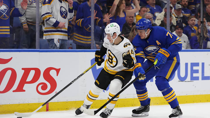 Apr 19, 2026; Buffalo, New York, USA; Boston Bruins center James Hagens (44) tries to control the puck as Buffalo Sabres center Tage Thompson (72) defends during the third period in game one of the first round of the 2026 Stanley Cup Playoffs at KeyBank Center. Mandatory Credit: Timothy T. Ludwig-Imagn Images