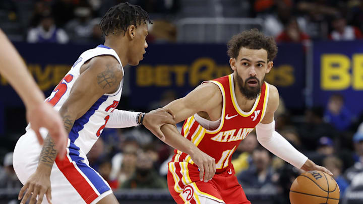 Feb 3, 2025; Detroit, Michigan, USA;  Atlanta Hawks guard Trae Young (11) dribbles defended by Detroit Pistons guard Marcus Sasser (25) in the second half at Little Caesars Arena. Mandatory Credit: Rick Osentoski-Imagn Images