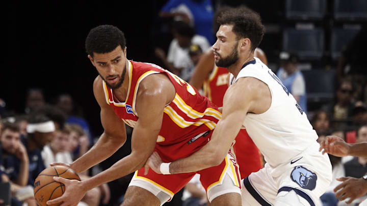 Oct 11, 2025; Memphis, Tennessee, USA; Atlanta Hawks guard Caleb Houstan (33) handles the ball as Memphis Grizzlies forward Tyler Burton (4) defends during the fourth quarter at FedExForum. Mandatory Credit: Petre Thomas-Imagn Images Oct 11, 2025; Memphis, Tennessee, USA; Atlanta Hawks guard Caleb Houstan (33) handles the ball as Memphis Grizzlies forward Tyler Burton (4) defends during the fourth quarter at FedExForum. Mandatory Credit: Petre Thomas-Imagn Images