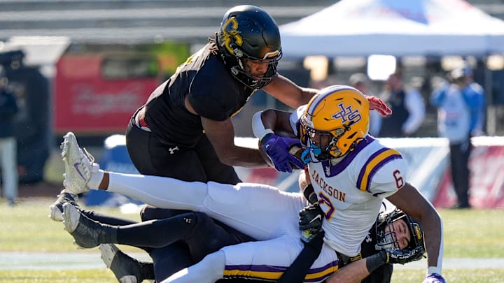 Dec 6, 2024; Birmingham, AL, USA; A trio of Cherokee County defenders bring down Jackson's Keeyun Chapman (6) at Protective Stadium in the AHSAA 4A State Championship game. Dec 6, 2024; Birmingham, AL, USA; A trio of Cherokee County defenders bring down Jackson's Keeyun Chapman (6) at Protective Stadium in the AHSAA 4A State Championship game.