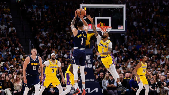 Apr 29, 2024; Denver, Colorado, USA; Denver Nuggets forward Michael Porter Jr. (1) attempts a shot as Los Angeles Lakers guard D'Angelo Russell (1) defends in the first quarter during game five of the first round for the 2024 NBA playoffs at Ball Arena. Mandatory Credit: Isaiah J. Downing-USA TODAY Sports