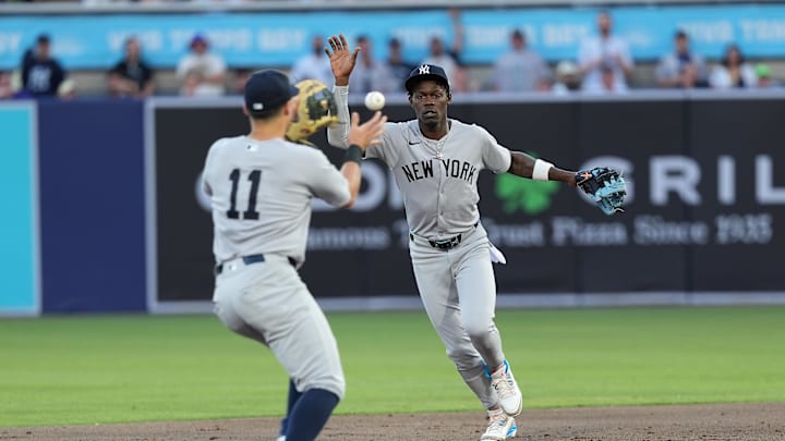 Apr 18, 2025; Tampa, Florida, USA; New York Yankees third baseman Jazz Chisholm Jr. (13) tosses the ball to shortstop Anthony Volpe (11) during the second inning at George M. Steinbrenner Field. Mandatory Credit: Dave Nelson-Imagn Images