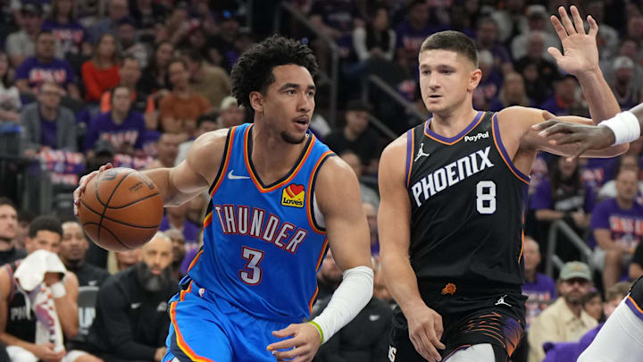 Apr 25, 2026; Phoenix, Arizona, USA; Oklahoma City Thunder guard Jared McCain (3) drives around Phoenix Suns guard Grayson Allen (8) in the first half during game three of the first round of the 2026 NBA Playoffs at Mortgage Matchup Center. Mandatory Credit: Rick Scuteri-Imagn Images