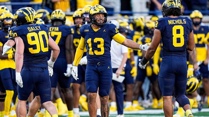 Michigan linebacker Aisea Moa (13) celebrates a play against Iowa with defensive end Dom Nichols (8) during the second half at Michigan Stadium in Ann Arbor on Saturday, Sept. 26, 2026. Michigan linebacker Aisea Moa (13) celebrates a play against Iowa with defensive end Dom Nichols (8) during the second half at Michigan Stadium in Ann Arbor on Saturday, Sept. 26, 2026.