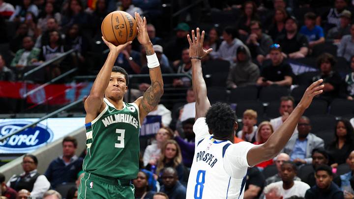 Oct 17, 2024; Dallas, Texas, USA;  Milwaukee Bucks forward MarJon Beauchamp (3) shoots as Dallas Mavericks forward Olivier-Maxence Prosper (8) defends during the second half at American Airlines Center. Mandatory Credit: Kevin Jairaj-Imagn Images