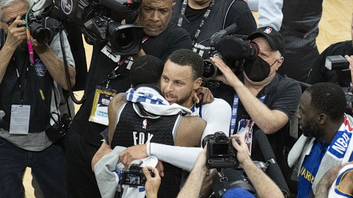 April 30, 2023; Sacramento, California, USA; Golden State Warriors guard Stephen Curry (30) hugs Sacramento Kings guard De'Aaron Fox (5) after game seven of the 2023 NBA playoffs first round at Golden 1 Center. Mandatory Credit: Kyle Terada-Imagn Images