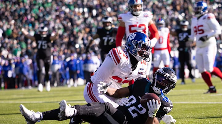 Jan 5, 2025; Philadelphia, Pennsylvania, USA; Philadelphia Eagles wide receiver Ainias Smith (82) makes a touchdown  catch past New York Giants safety Jason Pinnock (27) during the first quarter at Lincoln Financial Field. Mandatory Credit: Bill Streicher-Imagn Images