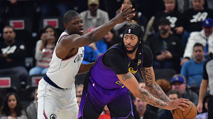 Jan 19, 2025; Inglewood, California, USA; Los Angeles Lakers forward Anthony Davis (3) controls the ball against Los Angeles Clippers center Mo Bamba (4) during the first half at Intuit Dome. Mandatory Credit: Gary A. Vasquez-Imagn Images