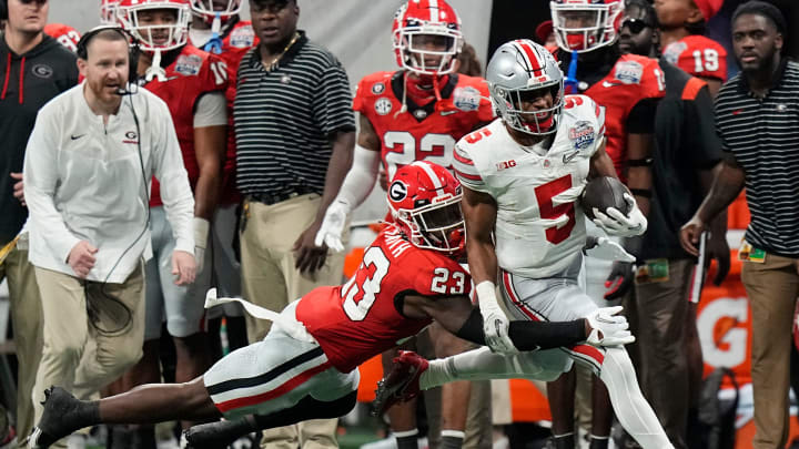 Dec 31, 2022; Atlanta, Georgia, USA; Ohio State Buckeyes running back Dallan Hayden (5) is forced Dec 31, 2022; Atlanta, Georgia, USA; Ohio State Buckeyes running back Dallan Hayden (5) is forced