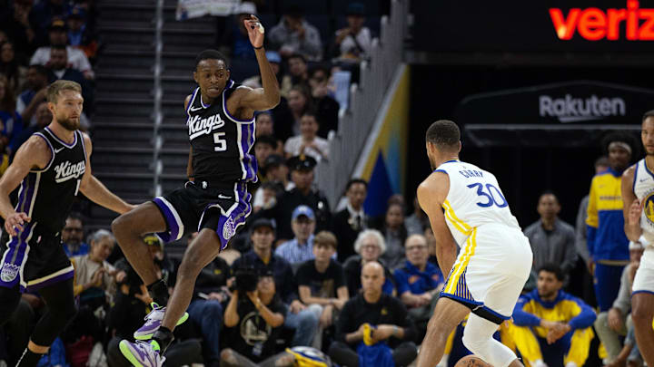 Oct 11, 2024; San Francisco, California, USA; Sacramento Kings guard De'Aaron Fox (5) leaves his feet to attempt to block a pass by Golden State Warriors guard Stephen Curry (30) during the first quarter at Chase Center. Mandatory Credit: D. Ross Cameron-Imagn Images