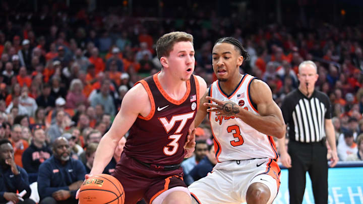 Feb 27, 2024; Syracuse, New York, USA; Virginia Tech Hokies guard Sean Pedulla drives the ball past Syracuse Orange guard Judah Mintz in the first half at the JMA Wireless Dome. Mandatory Credit: Mark Konezny-USA TODAY Sports