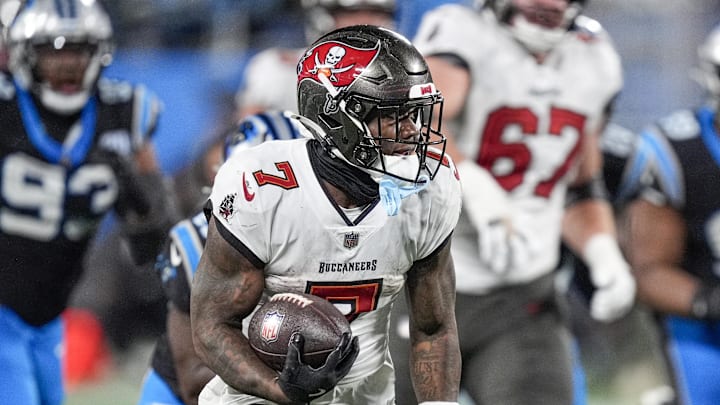 Dec 1, 2024; Charlotte, North Carolina, USA; Tampa Bay Buccaneers running back Bucky Irving (7) runs for yardage against the Carolina Panthers during the second half at Bank of America Stadium. Mandatory Credit: Jim Dedmon-Imagn Images