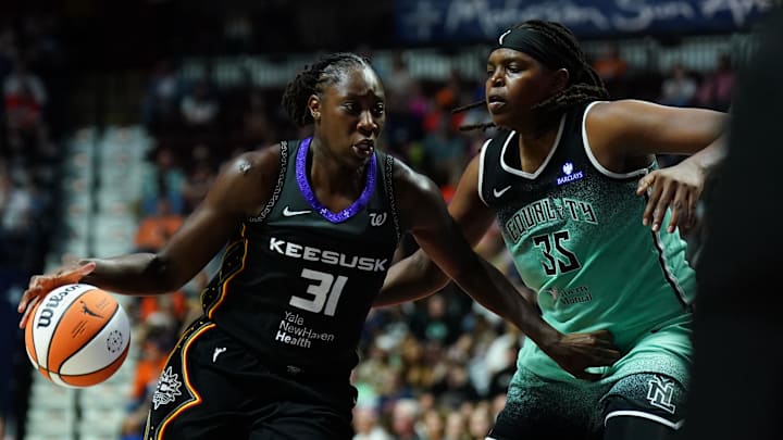 Aug 1, 2025; Uncasville, Connecticut, USA; Connecticut Sun center Tina Charles (31) drives the ball against New York Liberty center Jonquel Jones (35) in the first half at Mohegan Sun Arena. Mandatory Credit: David Butler II-Imagn Images