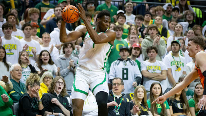 Oregon center N'Faly Dante leaps to keep the ball inbounds as the Oregon Ducks host the Oregon State Beavers.