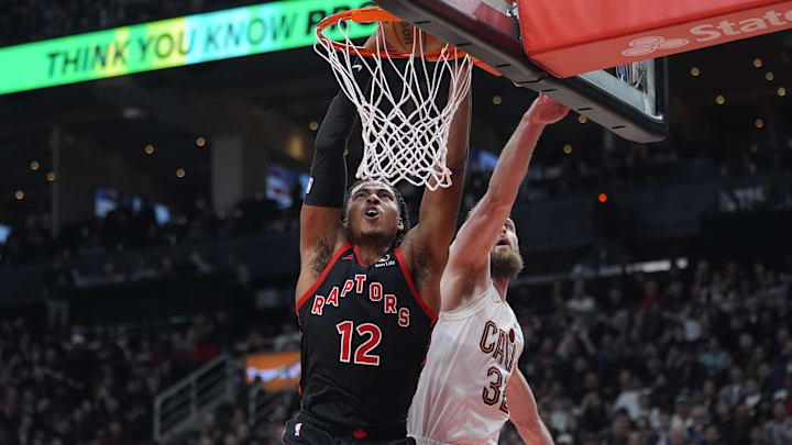 Apr 23, 2026; Toronto, Ontario, CAN; Toronto Raptors forward Collin Murray-Boyles (12) dunks against Cleveland Cavaliers forward Dean Wade (32) during the first half of game three of the first round of the 2026 NBA Playoffs at Scotiabank Arena.