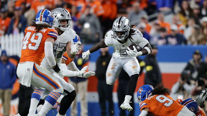 Nov 6, 2025; Denver, Colorado, USA; Las Vegas Raiders running back Ashton Jeanty (2) rushes the ball against the Denver Broncos during the first half at Empower Field at Mile High. Mandatory Credit: Isaiah J. Downing-Imagn Images