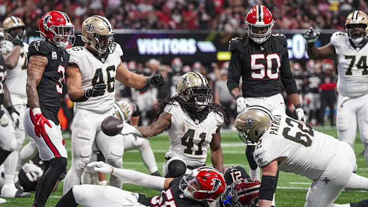 Sep 29, 2024; Atlanta, Georgia, USA; New Orleans Saints running back Alvin Kamara (41) reacts after scoring a touchdown past Atlanta Falcons linebacker Kaden Elliss (55) during the fourth quarter at Mercedes-Benz Stadium. Mandatory Credit: Dale Zanine-Imagn Images