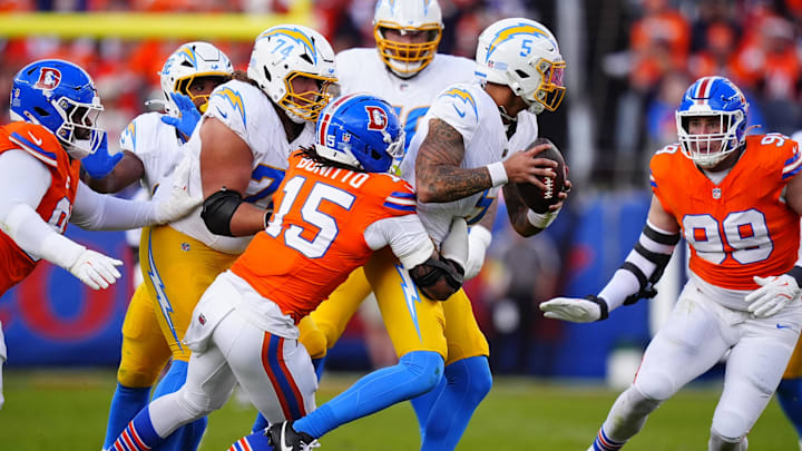 Jan 4, 2026; Denver, Colorado, USA; Denver Broncos linebacker Nik Bonitto (15) tackles Los Angeles Chargers quarterback Trey Lance (5) during the first half at Empower Field at Mile High. Mandatory Credit: Ron Chenoy-Imagn Images
