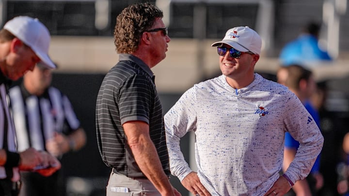 Oklahoma State head coach Mike Gundy and Tulsa head coach Tre Lamb talk before an NCAA football game between Oklahoma State (OSU) and Tulsa at Boone Pickens Stadium in Stillwater, Okla., on Friday, Sept. 19, 2025.